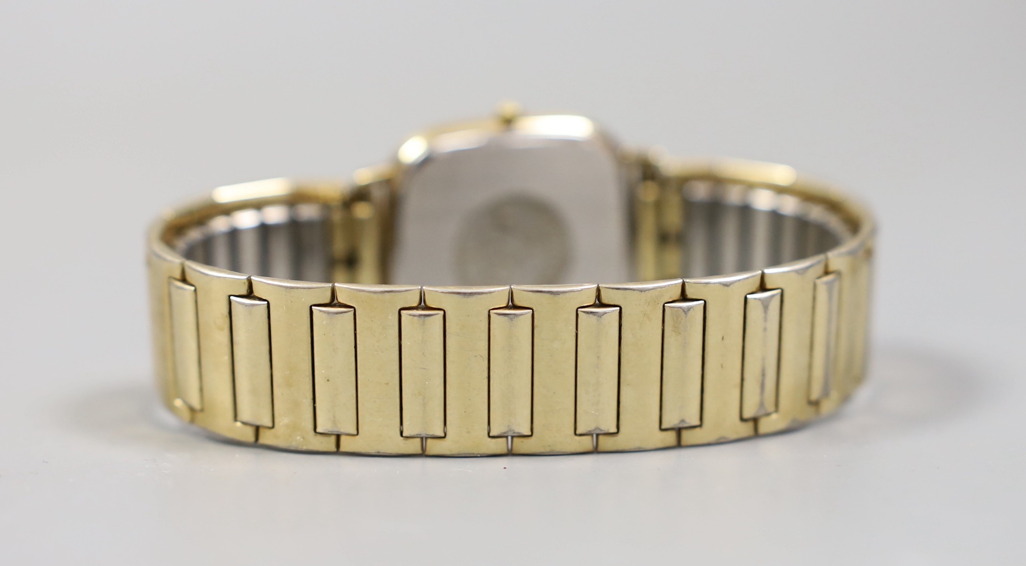 A gentleman's gold plated Omega Seamaster day/date quartz wrist watch, on associated flexible bracelet.